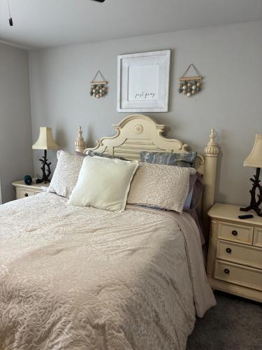 a bedroom with a bed and two night stands and two lamps at Your Honey Bee! Beautiful 2k sf! in Stillwater