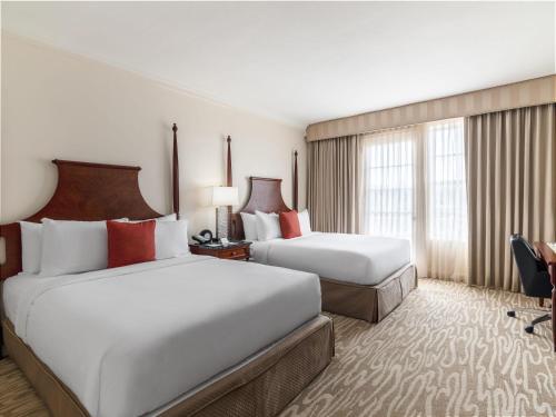 a hotel room with two beds and a window at Hamilton Princess & Beach Club A Fairmont Managed Hotel in Hamilton