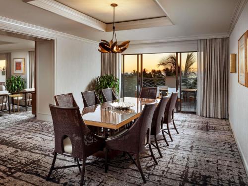 a dining room with a table and chairs at Fairmont Orchid in Waikoloa