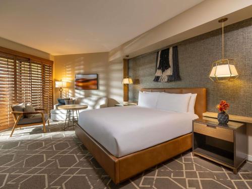 a bedroom with a large bed and a living room at Fairmont Scottsdale Princess in Scottsdale
