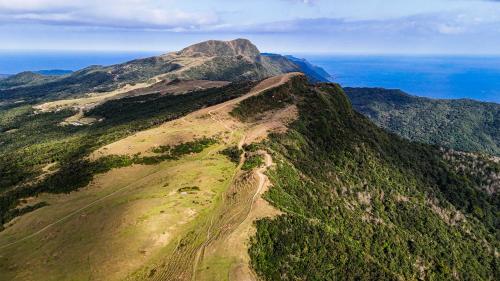 an aerial view of a mountain with the ocean at 眺浪島民宿 in Fan-shu-liao