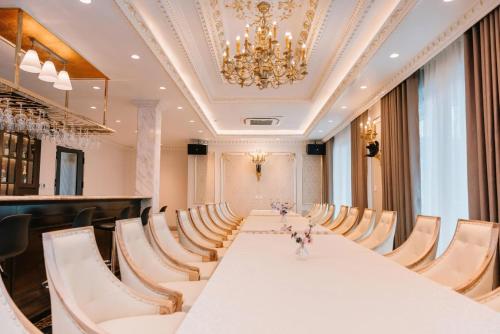 a large conference room with a long table and chairs at Diamond Hotel in Hai Phong