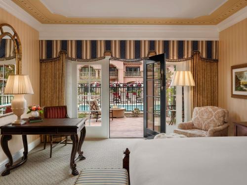 a living room with a desk and a chair at Fairmont Grand Del Mar in San Diego