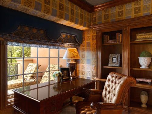 a home office with a glass desk and a chair at Fairmont Grand Del Mar in San Diego