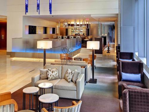 a lobby with a couch and chairs and a bar at Fairmont Pittsburgh in Pittsburgh