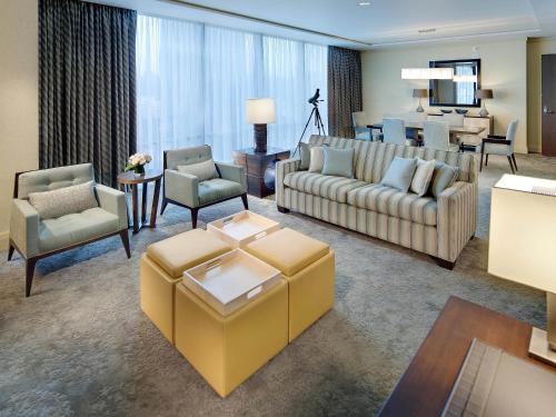 a living room with couches and a dining room at Fairmont Pittsburgh in Pittsburgh