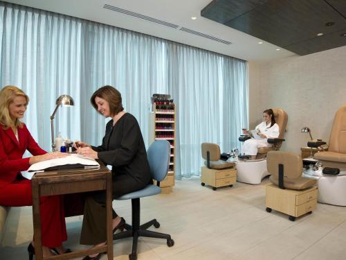 two women sitting at a desk in a salon at Fairmont Pittsburgh in Pittsburgh