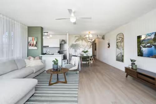 a living room with a couch and a table at Beachfront Bliss 2BR Broadbeach in Gold Coast