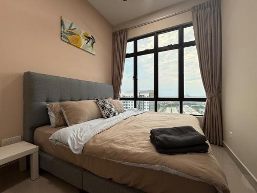 a bedroom with a bed with a large window at MountAustin Projector 3BR 8pax NEW in Johor Bahru