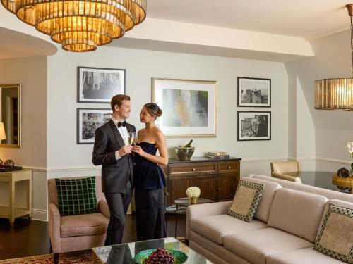 a man and a woman standing in a living room at Fairmont Le Chateau Frontenac in Quebec City