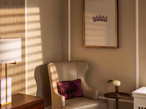 a chair with a pillow in a room at Fairmont Empress Hotel in Victoria