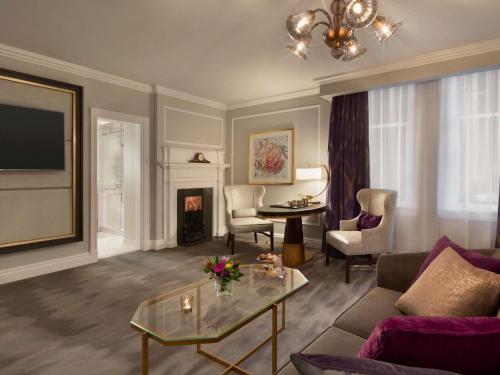 a living room with a couch and a table at Fairmont Empress Hotel in Victoria