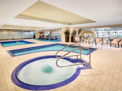 a swimming pool in the middle of a hotel lobby at Fairmont Vancouver Airport In-Terminal Hotel in Richmond