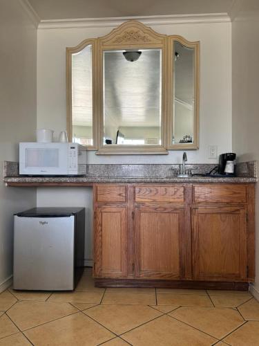 a kitchen with a sink and a microwave at The Shores Inn in Ventura