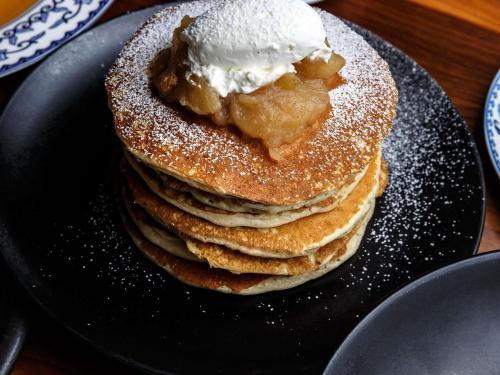 a stack of pancakes with ice cream on a plate at Fairmont Hotel Vancouver in Vancouver