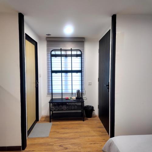 a bedroom with a door open to a room with a table at dChamp Retreat in Changlun