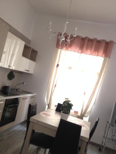 a small kitchen with a table and a window at Sweet Holiday Home in Bernalda