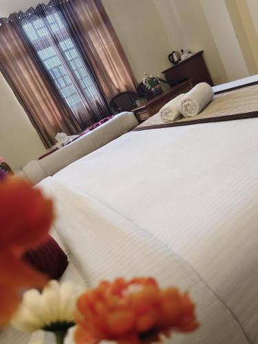 a bedroom with a white bed and a window at Parasol Norling Hotel & Spa in Jāmb