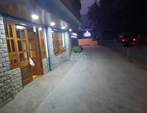a building with a car parked on a street at night at Parasol Norling Hotel & Spa in Jāmb