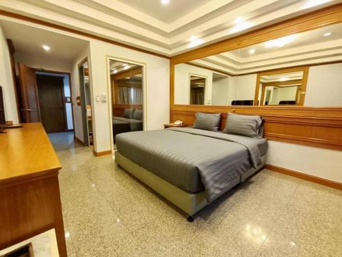 a bedroom with a large bed in a room at New Siya in Maha Sarakham