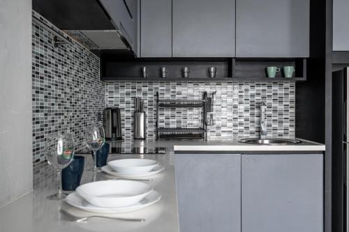 a kitchen with two white plates and a sink at Luxury 1BR Resort Retreat by IBG Property P514 in Kamala Beach