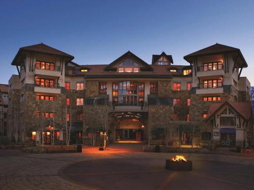 a large building with a fire in front of it at Fairmont Heritage Place, Franz Klammer Lodge in Telluride