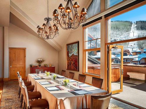 a large dining room with a long table and chairs at Fairmont Heritage Place, Franz Klammer Lodge in Telluride