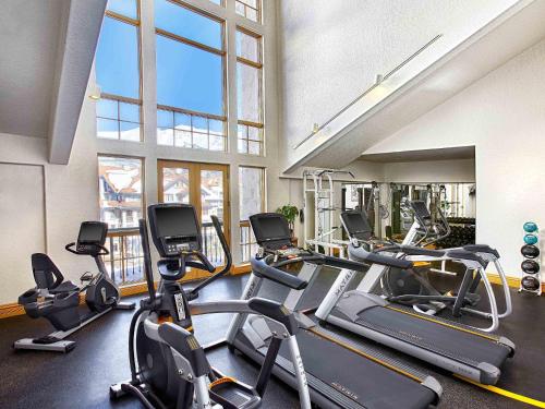 a gym with several treadmills and elliptical machines at Fairmont Heritage Place, Franz Klammer Lodge in Telluride