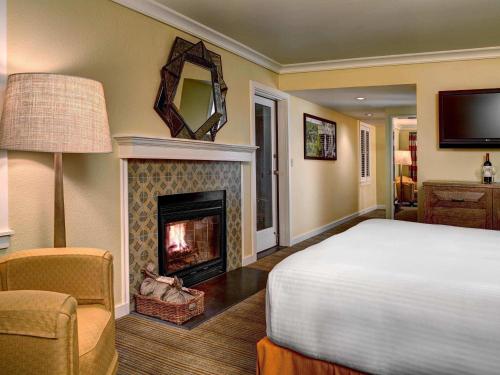 a bedroom with a bed and a fireplace at Fairmont Sonoma Mission Inn & Spa in Sonoma