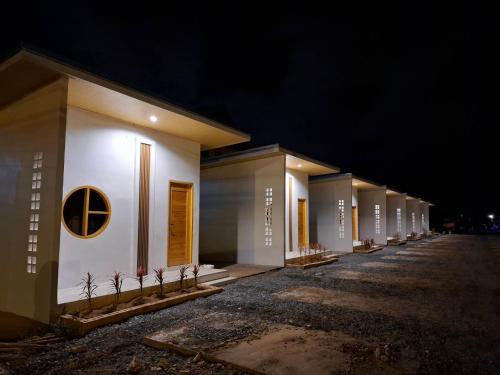 a row of white buildings at night at บีริช รีสอร์ท ขอนแก่น in Khon Kaen