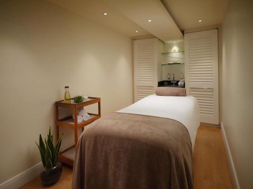 a bedroom with a large bed in a room at The Savoy in London