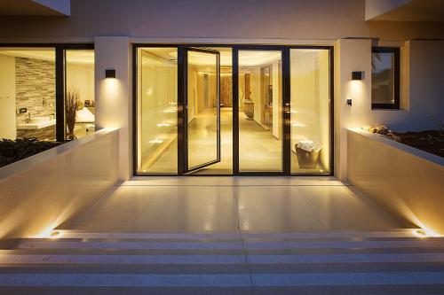 a staircase leading to a house with glass doors at Hotel Villa Margaret in Malinska