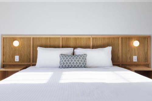 a bedroom with a white bed with two pillows at Mortdale Hotel in Mortdale
