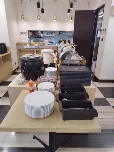 a kitchen with plates on a table in a restaurant at Hotel Yah Hanoi & Spa in Hanoi