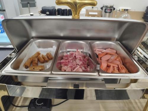 a tray of different types of food in a sink at Hotel Yah Hanoi & Spa in Hanoi
