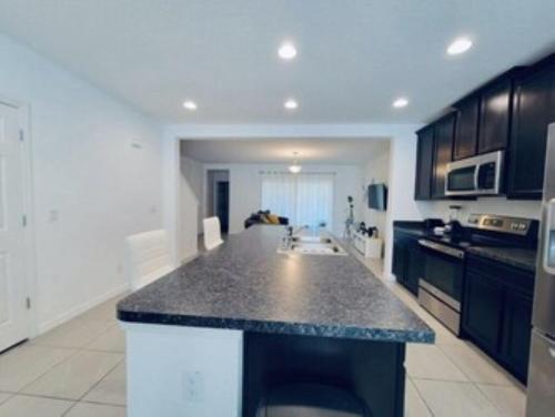 a kitchen with a large island in a kitchen at Primrose Villa in Davenport