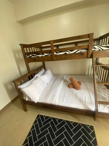 a bedroom with two bunk beds and a rug at Bright Retreat Blending Style and Comfort in Mandurriao