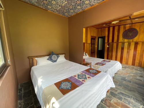 a room with two beds in a room at Quế Homestay in Hòa Bình