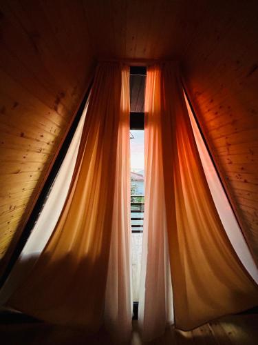 a curtain in a room with a window at Rakushki's house 2 in K'obulet'i