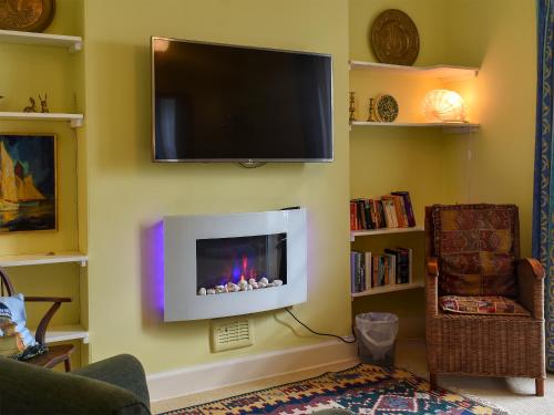 a living room with a flat screen tv on a wall at St Abbs - Lighthouse Retreat in Saint Abbs