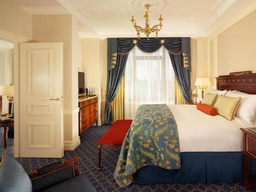 a hotel room with a large bed and a window at Fairmont Grand Hotel Kyiv in Kyiv