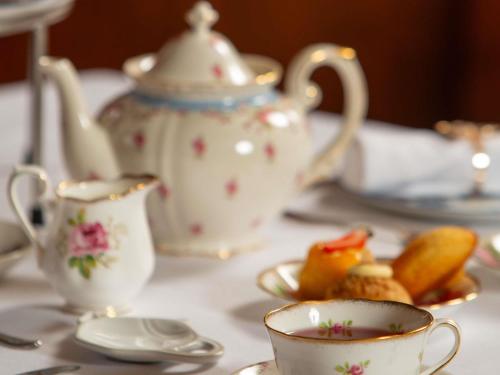 a table with tea cups and saucers on it at Fairmont Winnipeg in Winnipeg