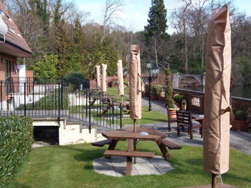 a picnic table in the grass next to a playground at Lakeside International Hotel in Camberley
