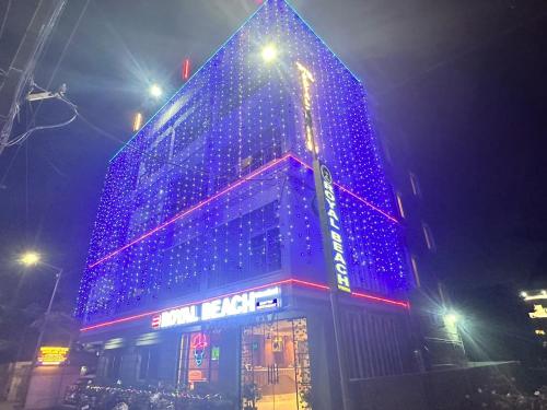 a building with blue lights on it at night at Royal Beach International in Puri