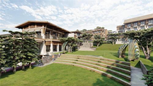 a view of a building with a green lawn at Jambuluwuk Bromo Resort in Pasuruan