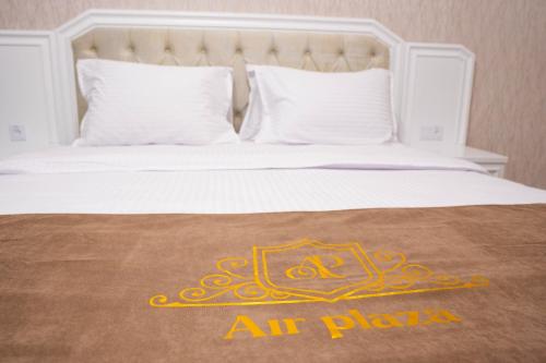 a white bed with an air plane sign on it at Air Plaza in Samarkand