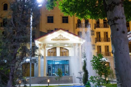 a building with a fountain in front of it at Air Plaza in Samarkand