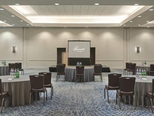 a conference room with tables and chairs and a screen at Fairmont St Andrews, Scotland in St. Andrews