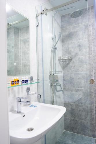 a bathroom with a sink and a glass shower at Air Plaza in Samarkand