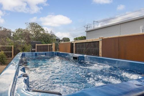 a swimming pool on the side of a house at PI Hot Springs Retreat1 in Surf Beach